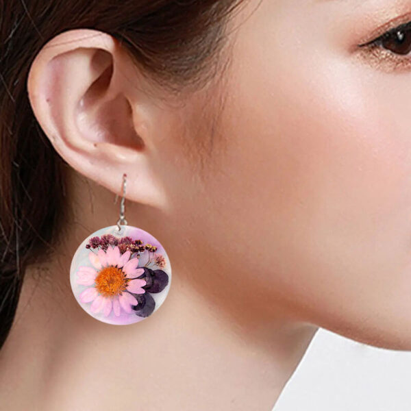 woman wearring resin earrings